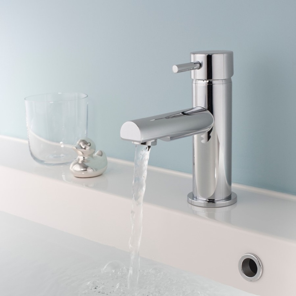 Product Lifestyle image of the Crosswater Kai Lever Basin Monobloc next to a tumbler and small chrome duck